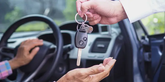 A senior transportation driver assisting an older adult into a vehicle, highlighting patience and empathy in providing essential services. by Nutmeg Senior Riders